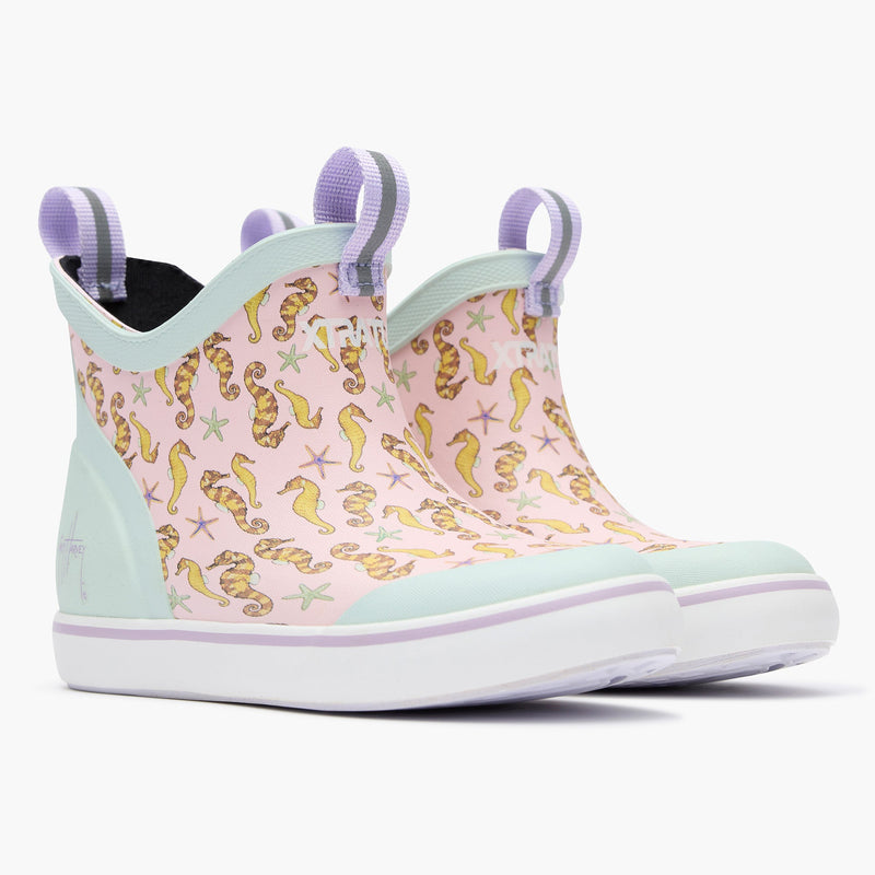 Pink and gold seahorse-patterned shoe with light blue accents on a white background