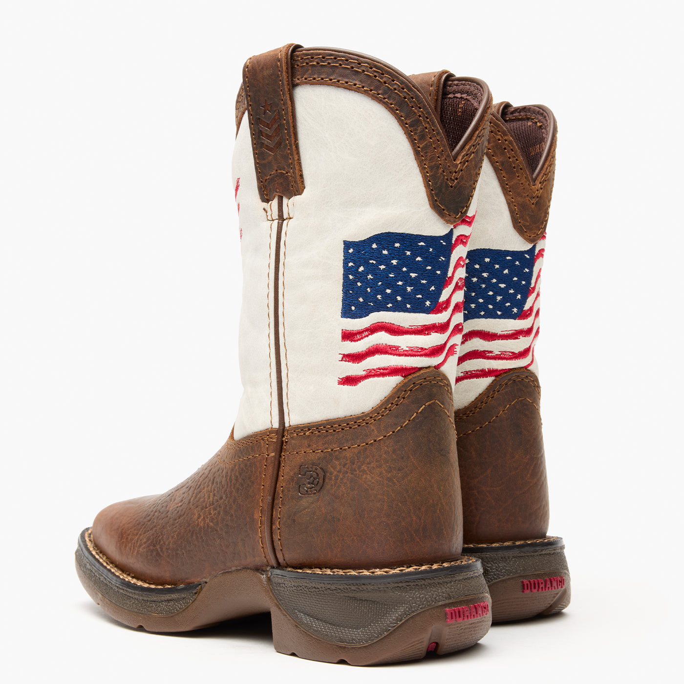 Brown and white kids western boot with American flag design on a grey background