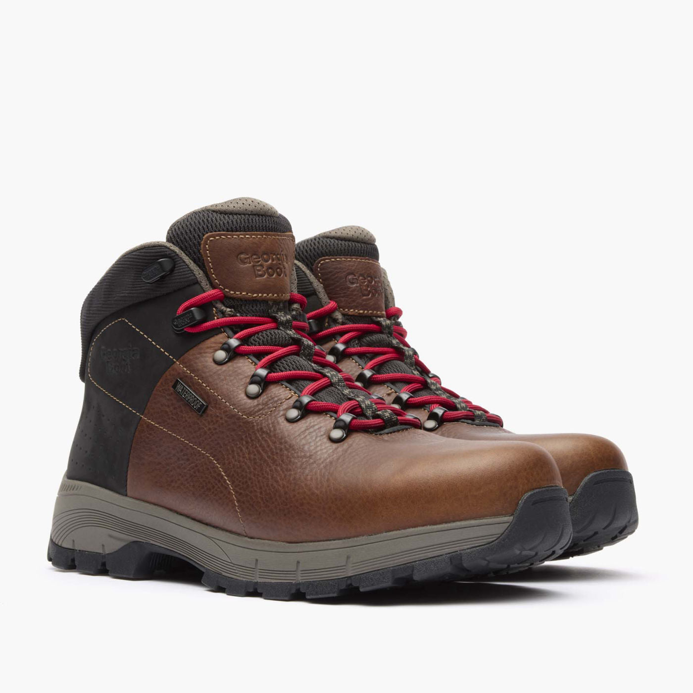 Brown hiking boots with red laces on a white background