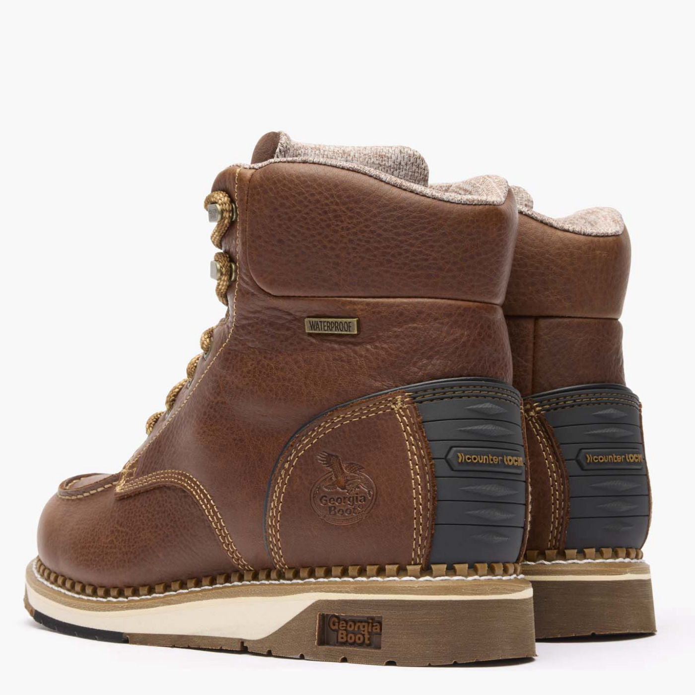 Brown leather boots with visible brand logo on a white background