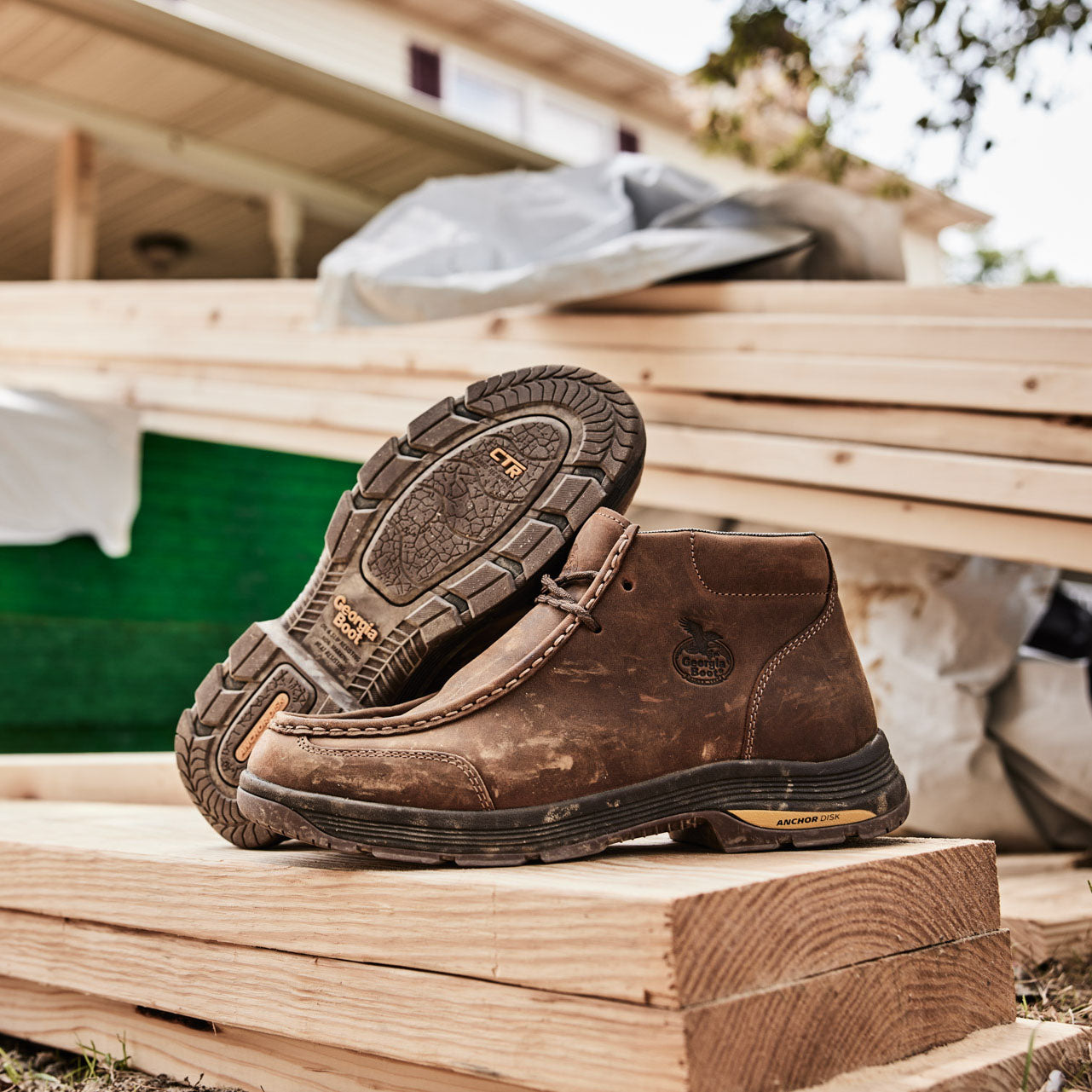 Boots sitting on top of wood pile