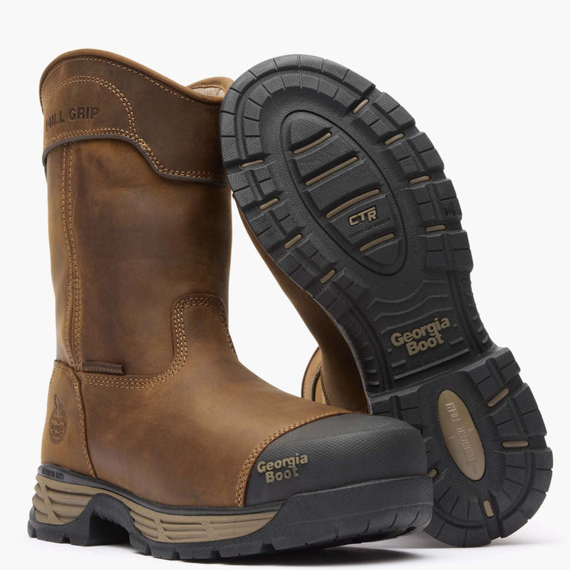 Brown work boot with black sole on a white background