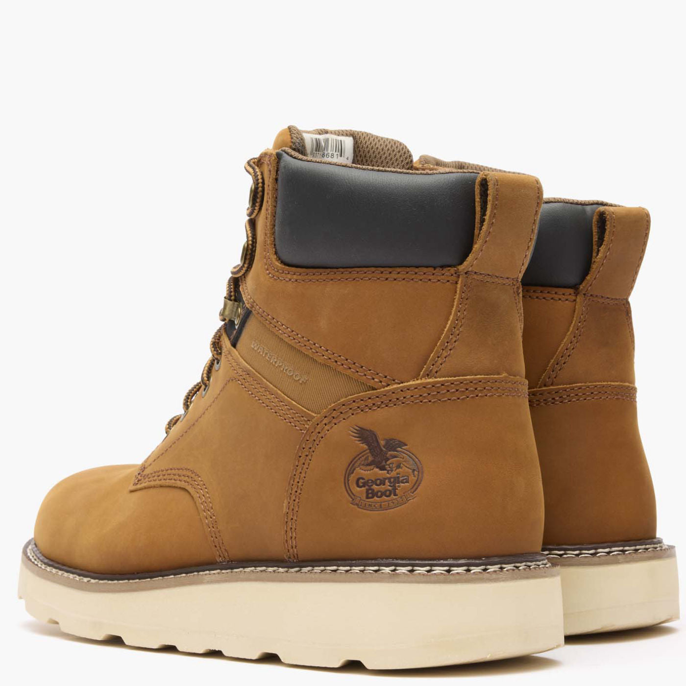 Pair of brown work boots with a visible brand logo on a white background