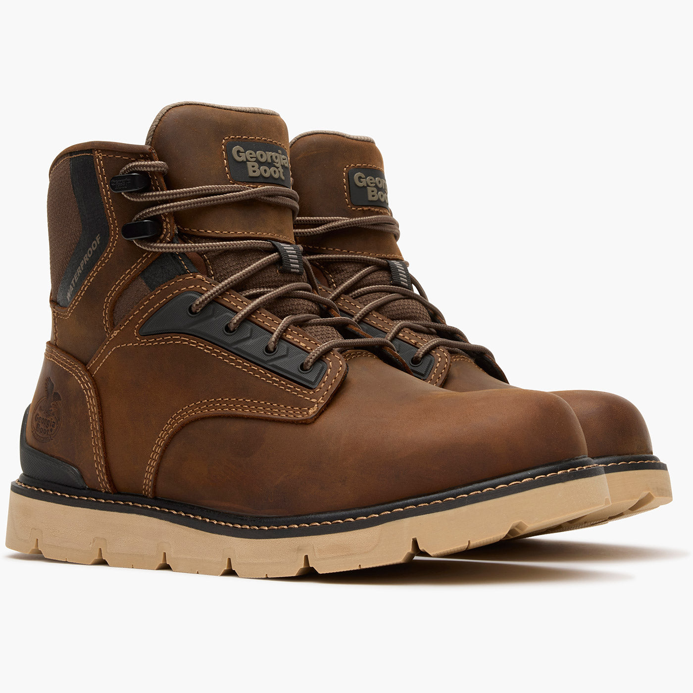 Brown leather boots with black accents on a white background