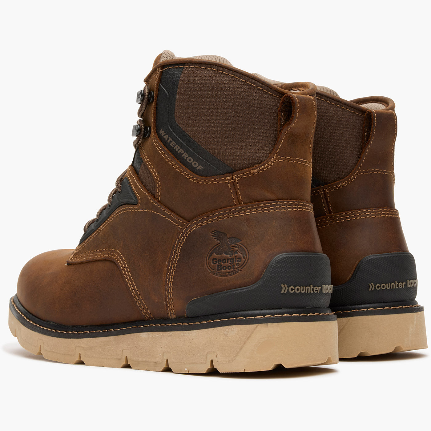 Pair of brown work boots with visible brand logo on a white background