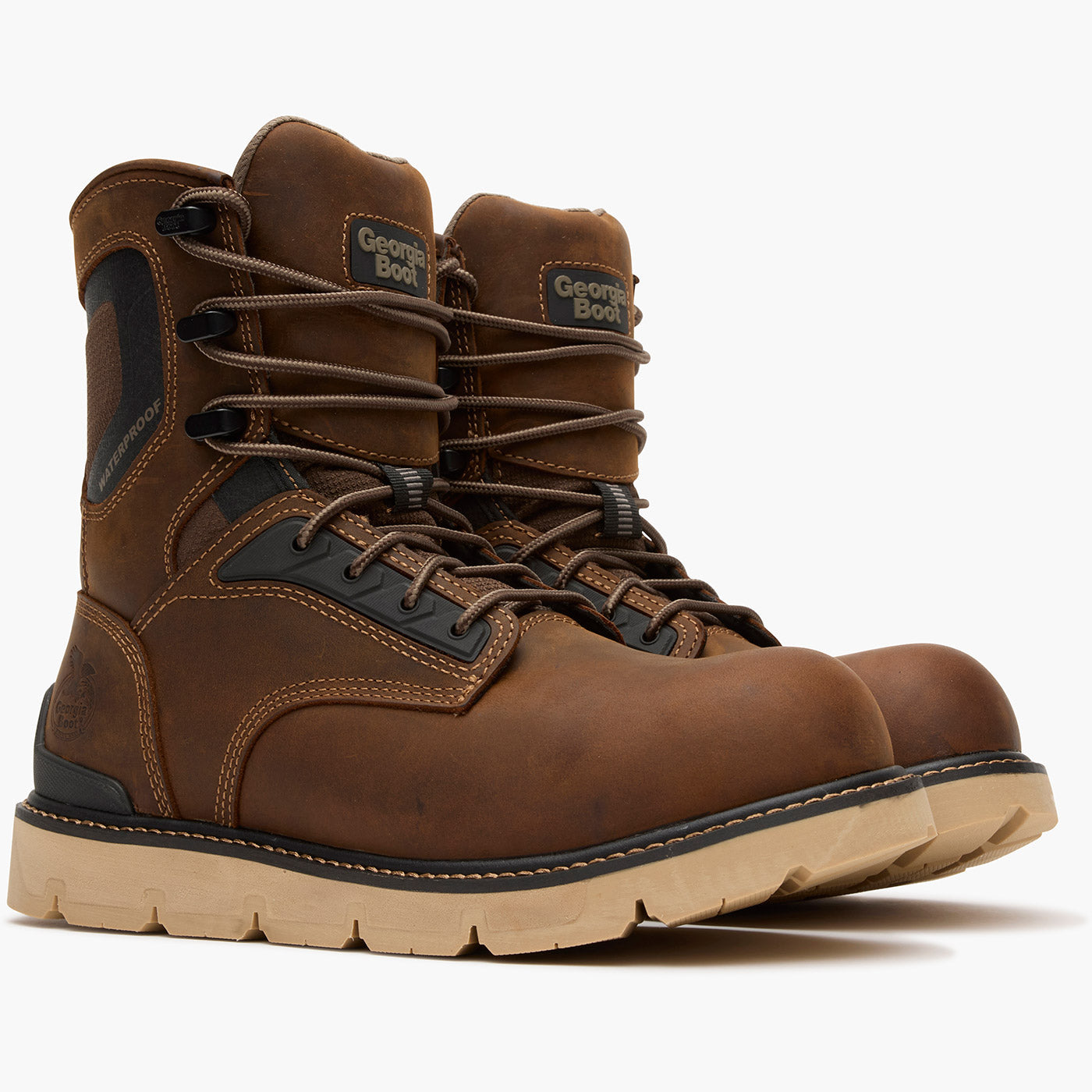 Pair of brown work boots with visible brand logo on a white background
