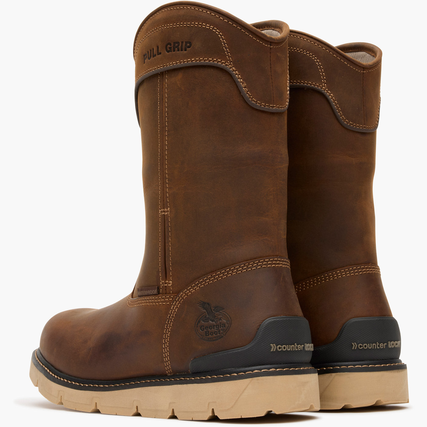 Pair of brown work boots with 'Caterpillar' branding on a white background