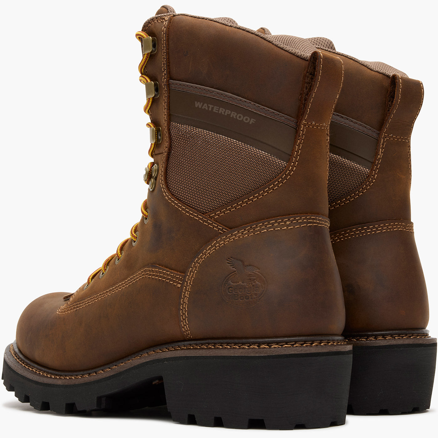 Pair of brown leather boots with visible brand logo on a white background
