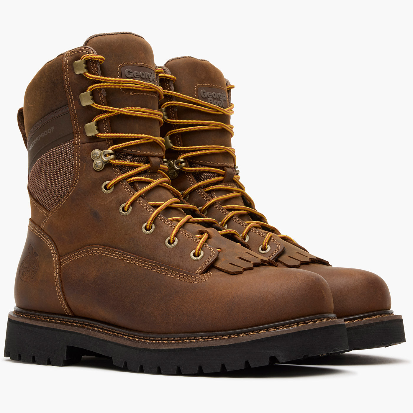 Pair of brown leather boots with yellow laces on a white background