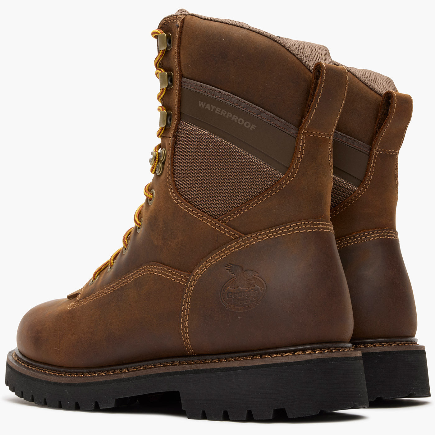 Pair of brown leather boots with visible brand logo on a white background