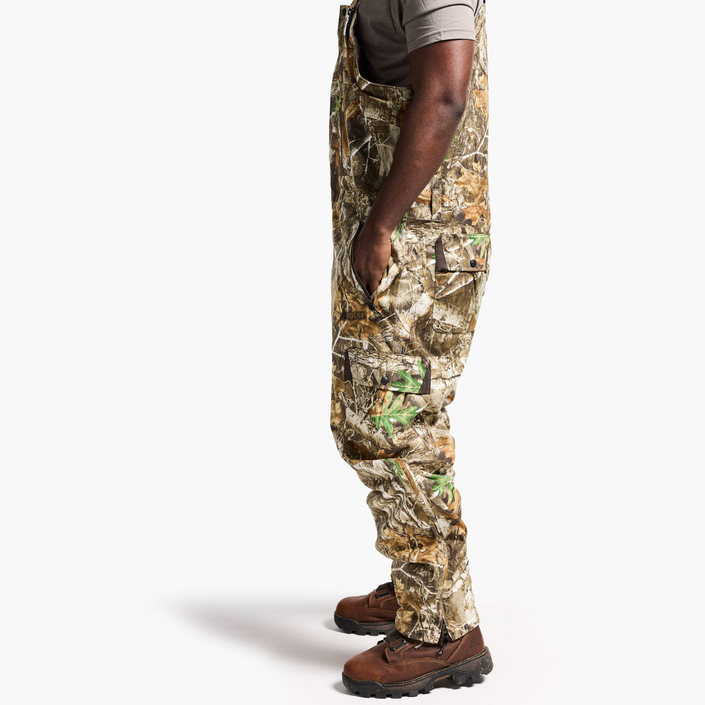 Person wearing camouflage hunting pants on a white background
