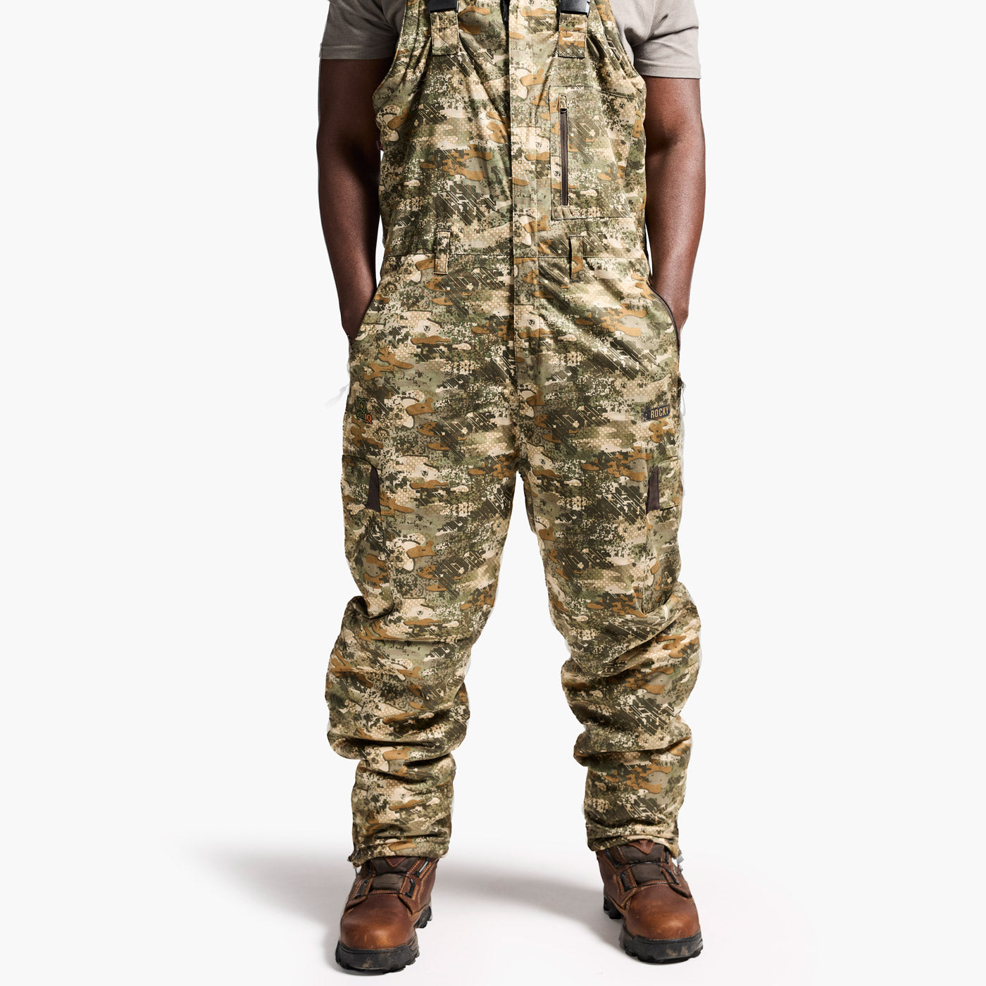 Camouflage overalls worn by a person on a white background
