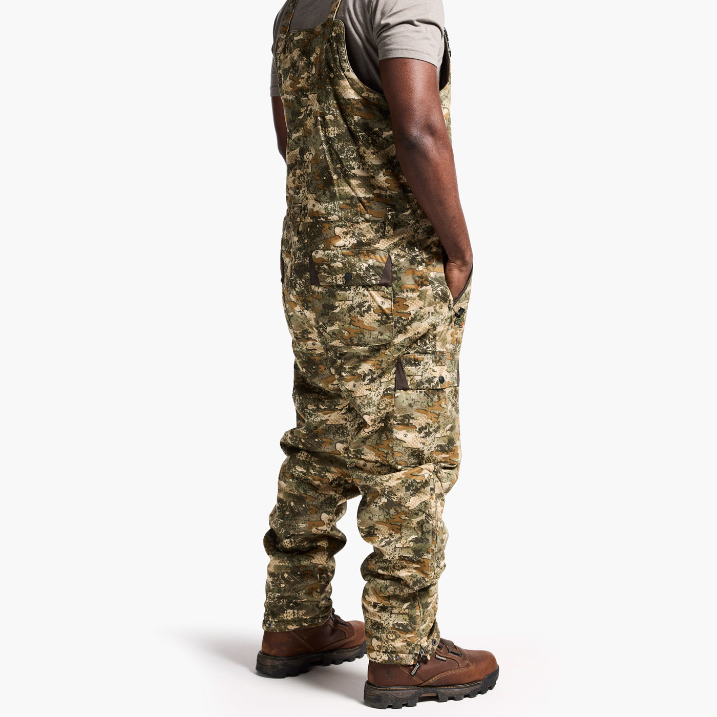 Person wearing camouflage overalls on a white background