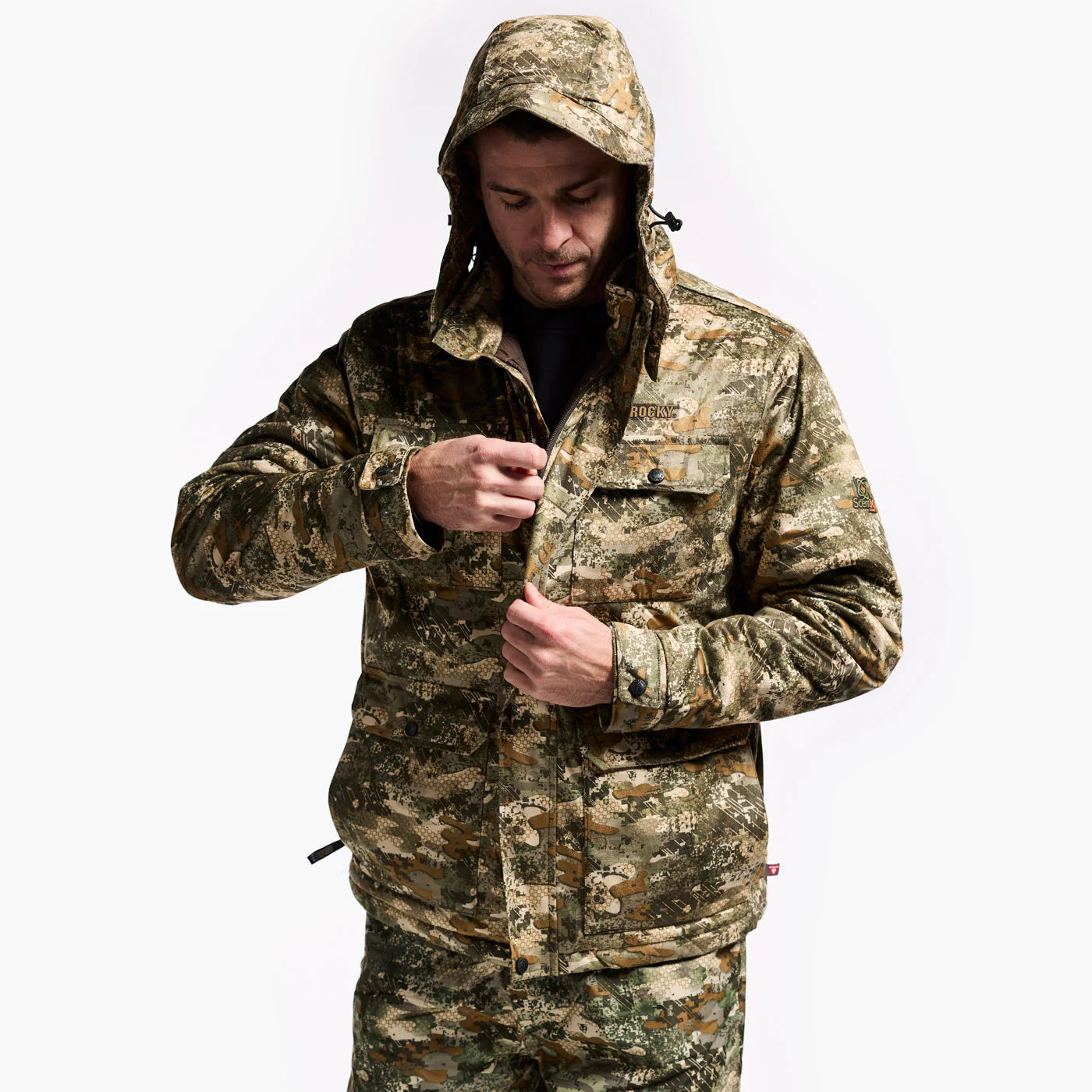 Person wearing a camouflage jacket and pants on a white background
