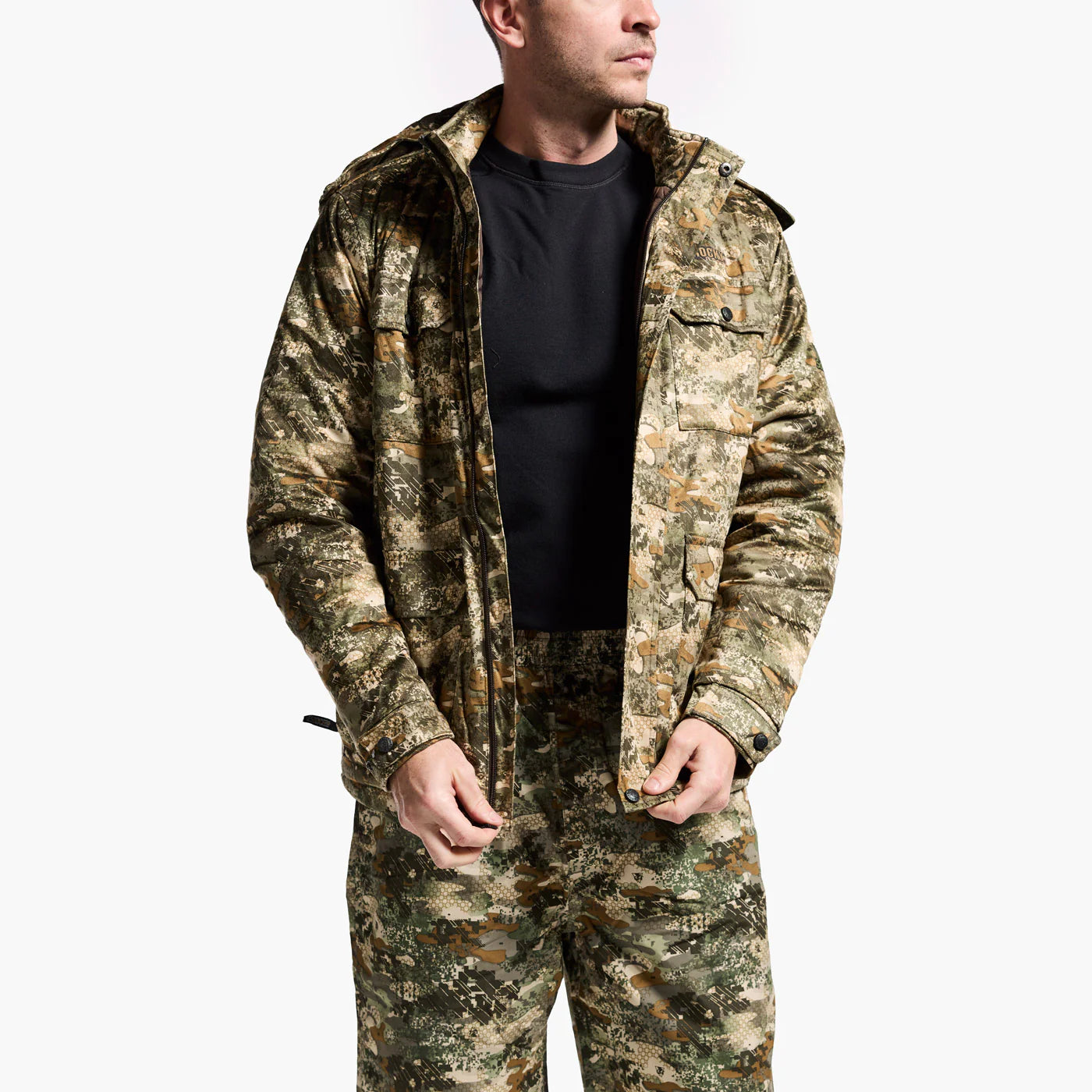 Person wearing a camouflage jacket and pants on a white background