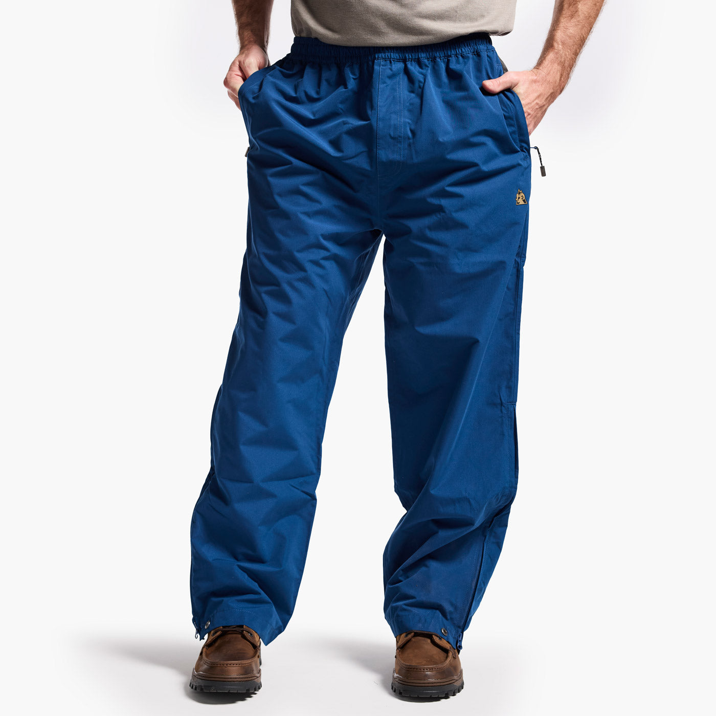 Blue pants worn by a person on a white background