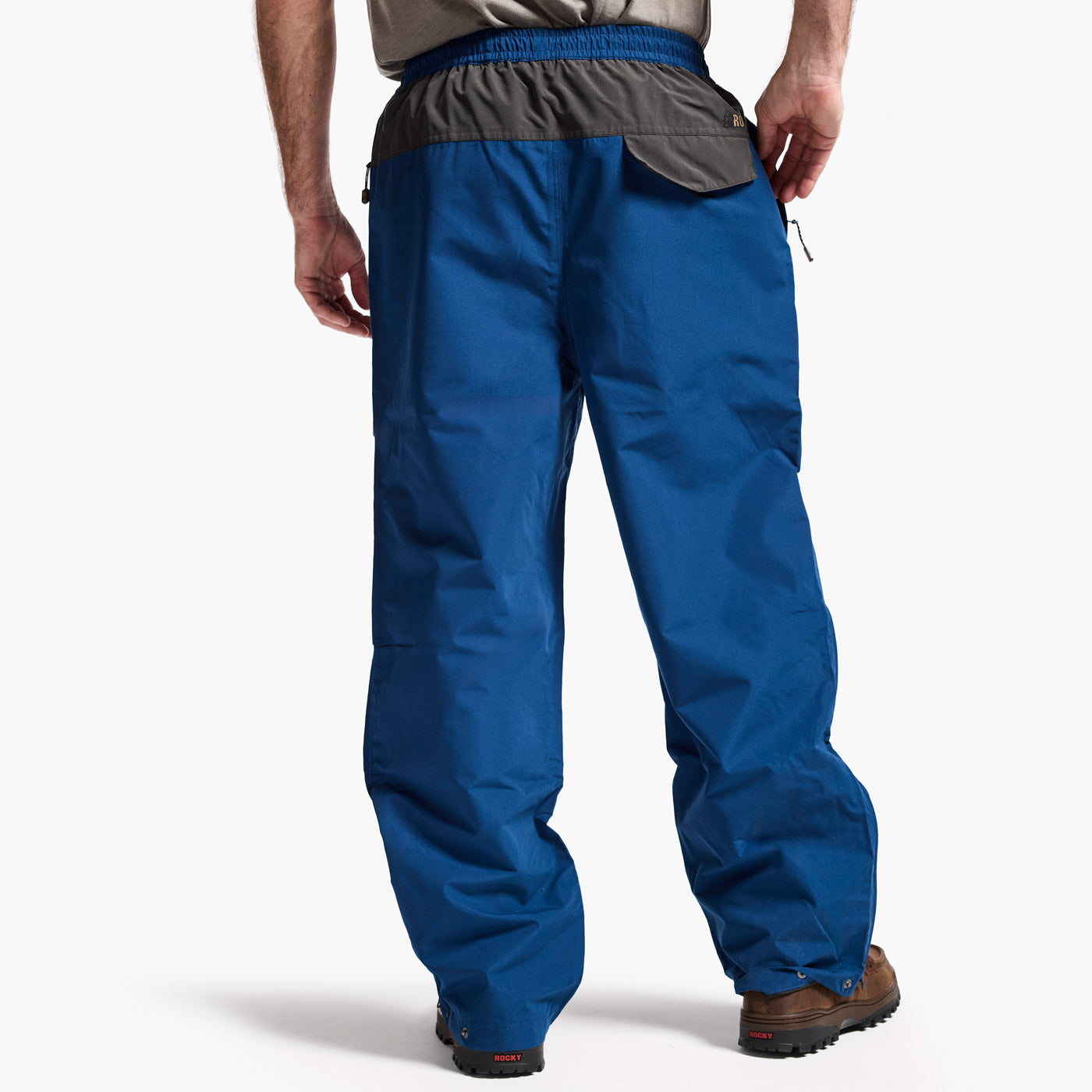 Blue pants worn by a person on a white background