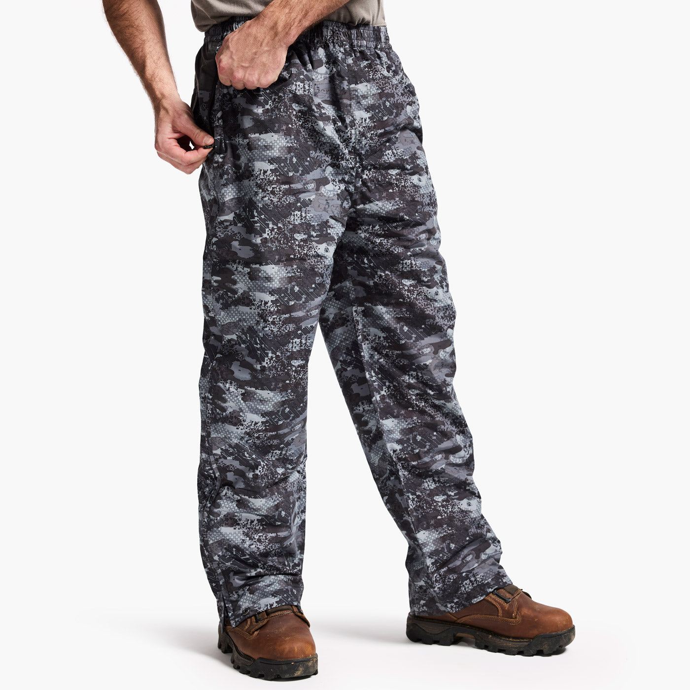 Person wearing camouflage pants on a white background