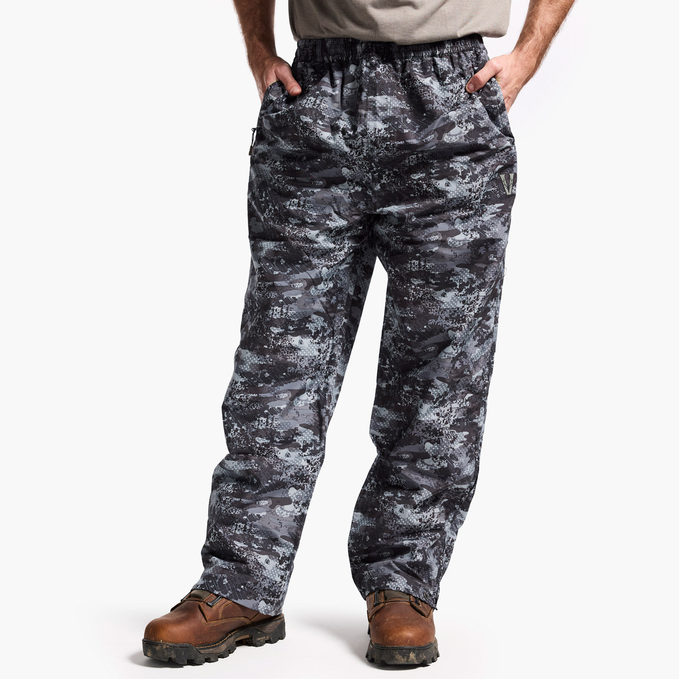 Digital camouflage pants worn by a person on a white background