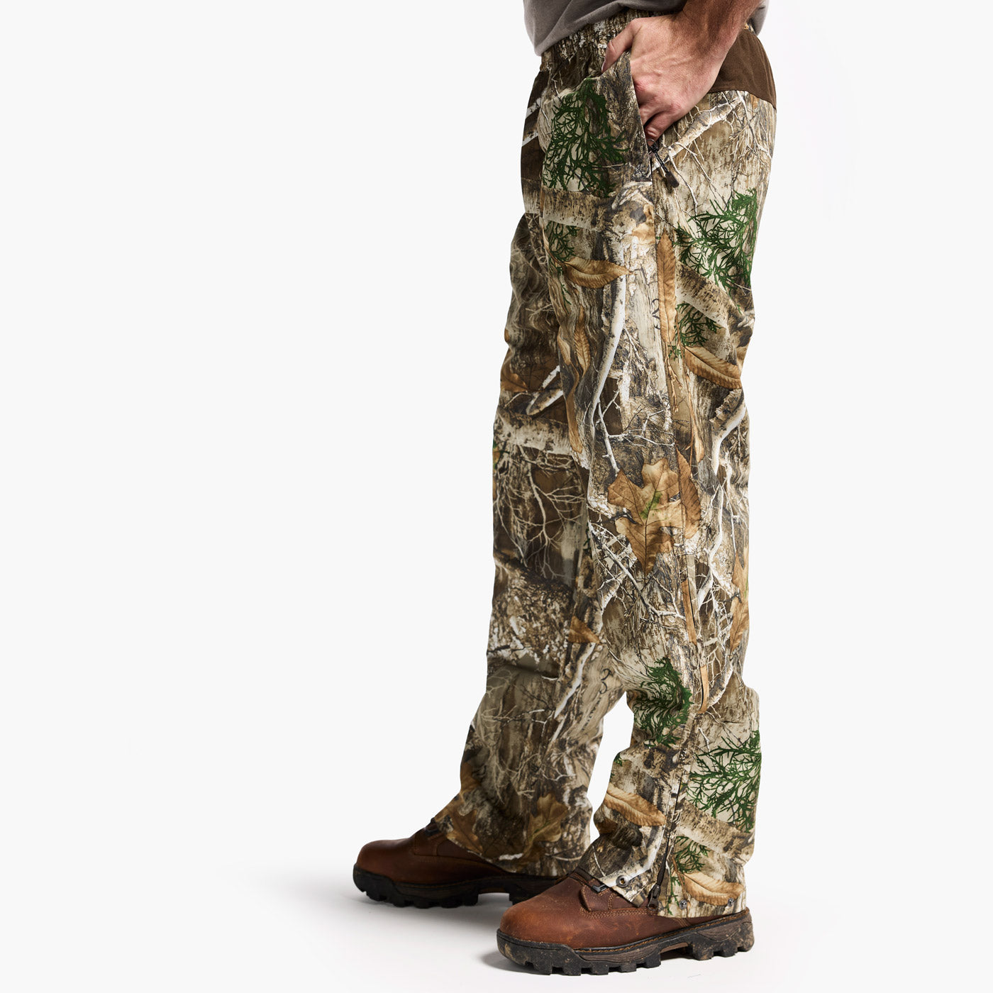 Camouflage hunting pants worn by a person on a white background