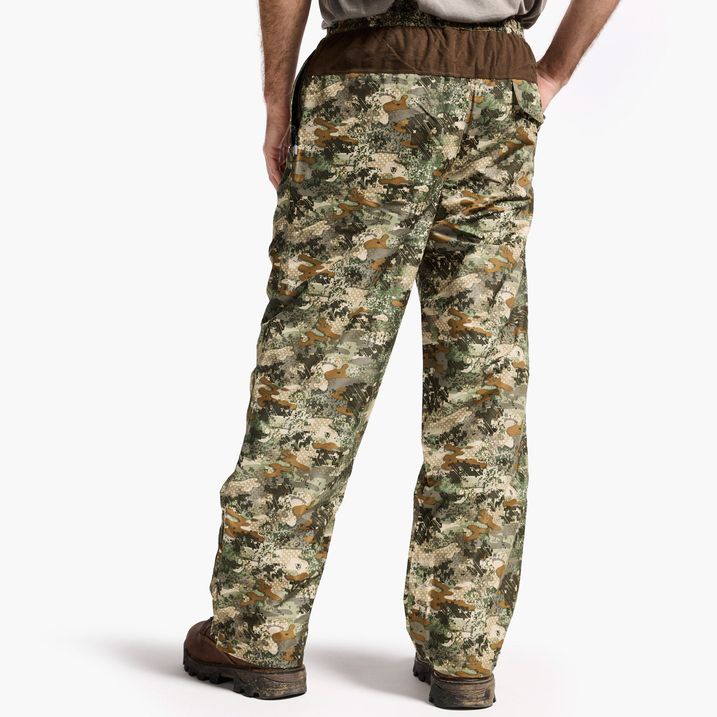 Camouflage pants worn by a person on a white background