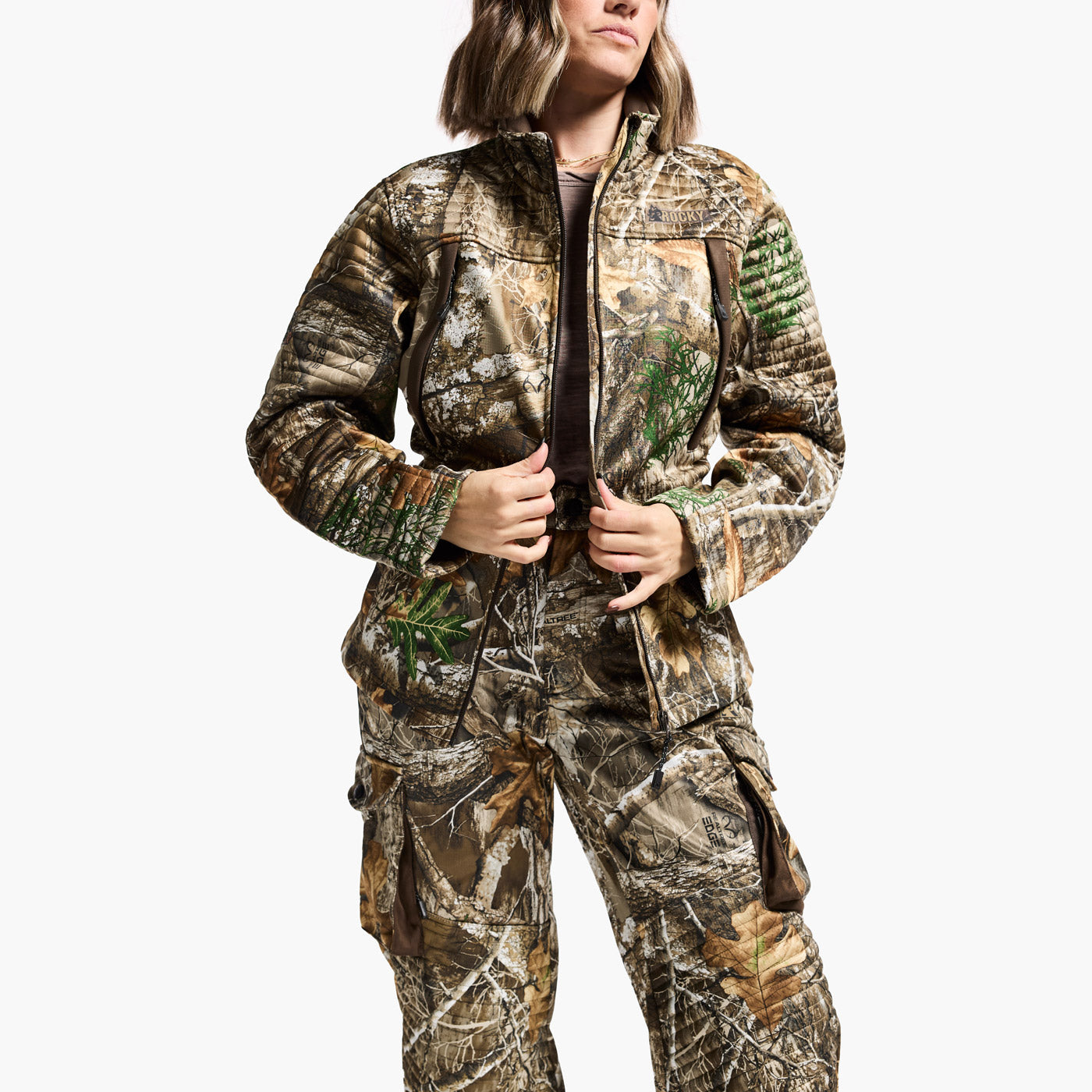 Person wearing a camouflage hunting suit on a white background