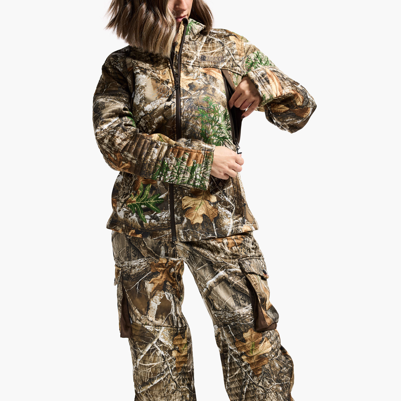 Person wearing a camouflage hunting suit on a white background