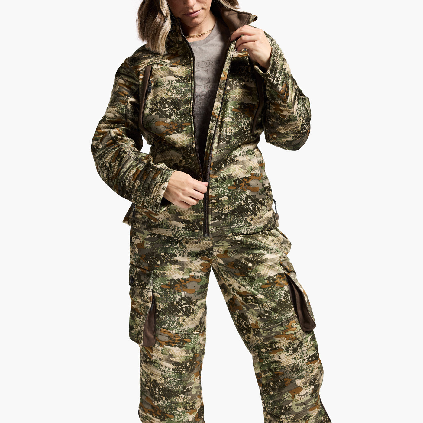 Person wearing a camouflage hunting suit on a white background