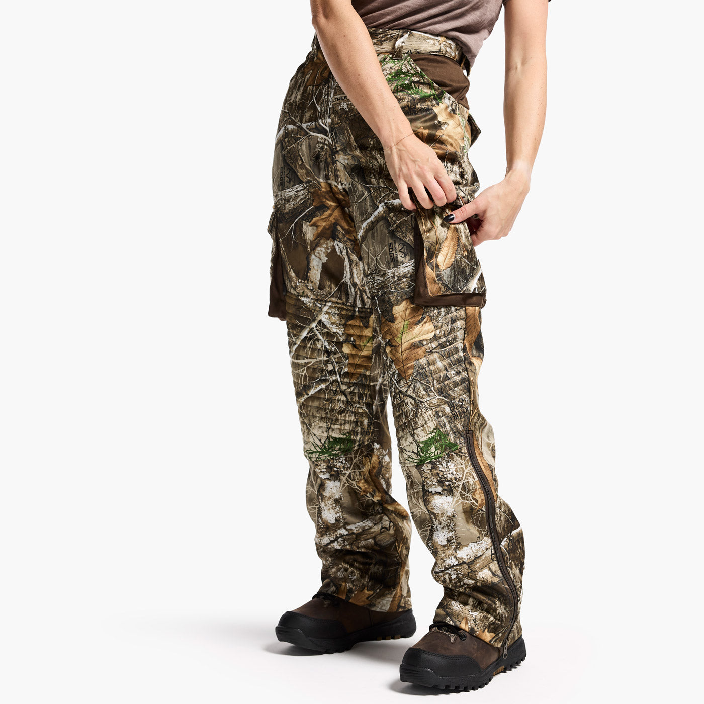 Camouflage pants worn by a person on a white background