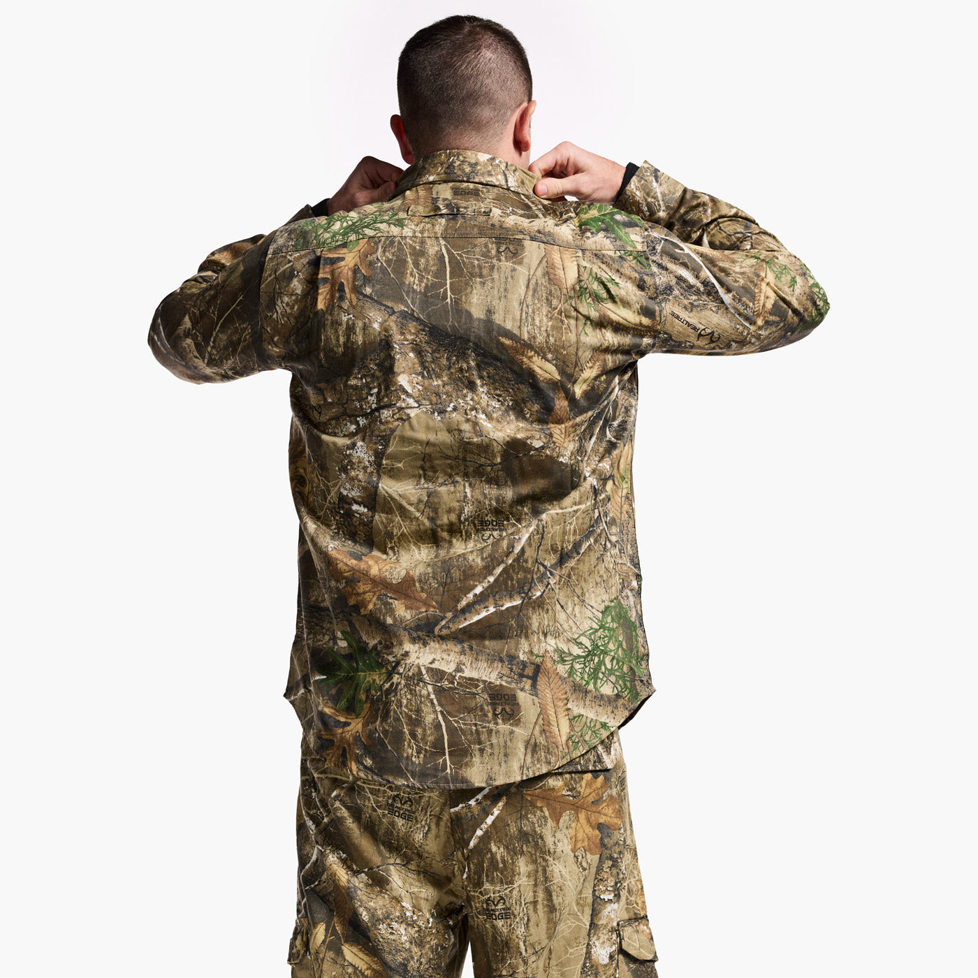 Person wearing a camouflage outfit on a white background