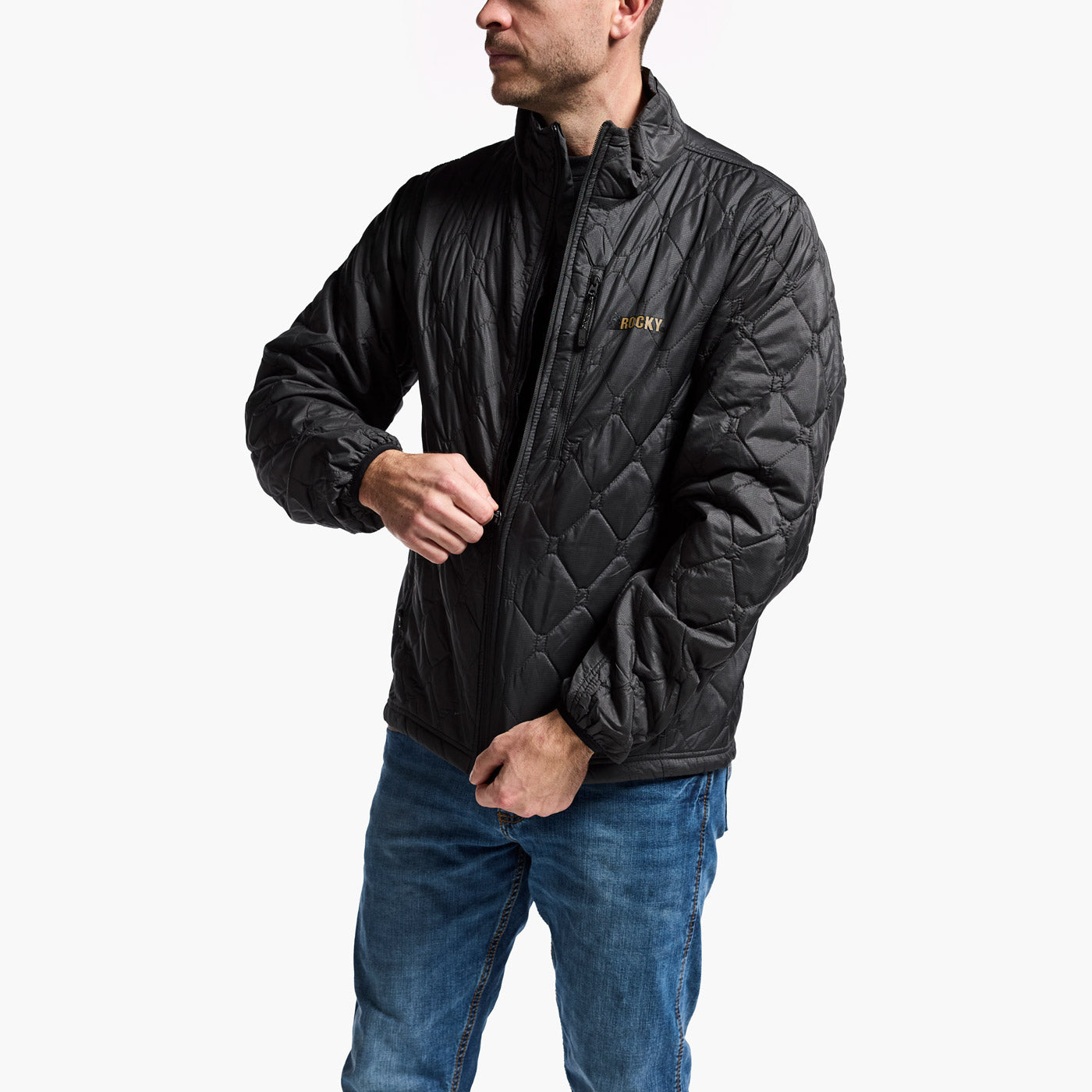 Man wearing a black quilted jacket with a brand logo on a white background