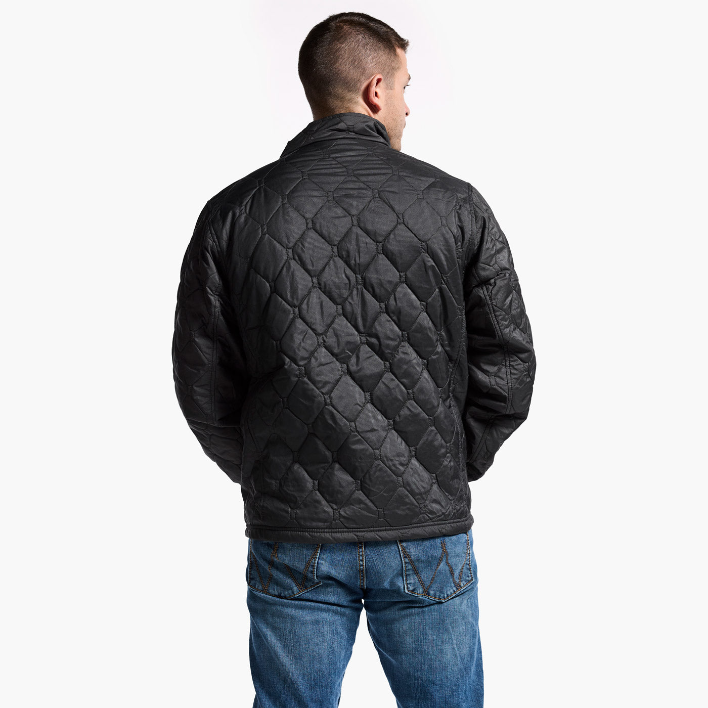 Man wearing a black quilted jacket on a white background