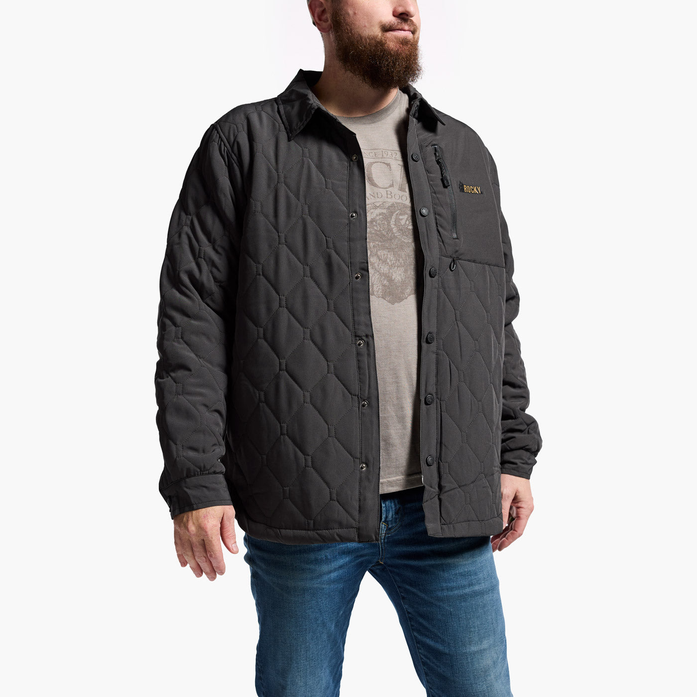 Man wearing a quilted jacket with a brand logo on a white background