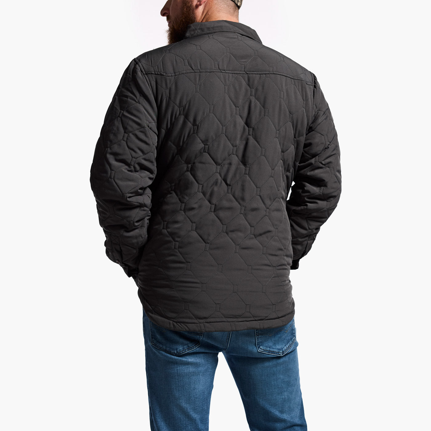 Person wearing a black quilted jacket on a white background