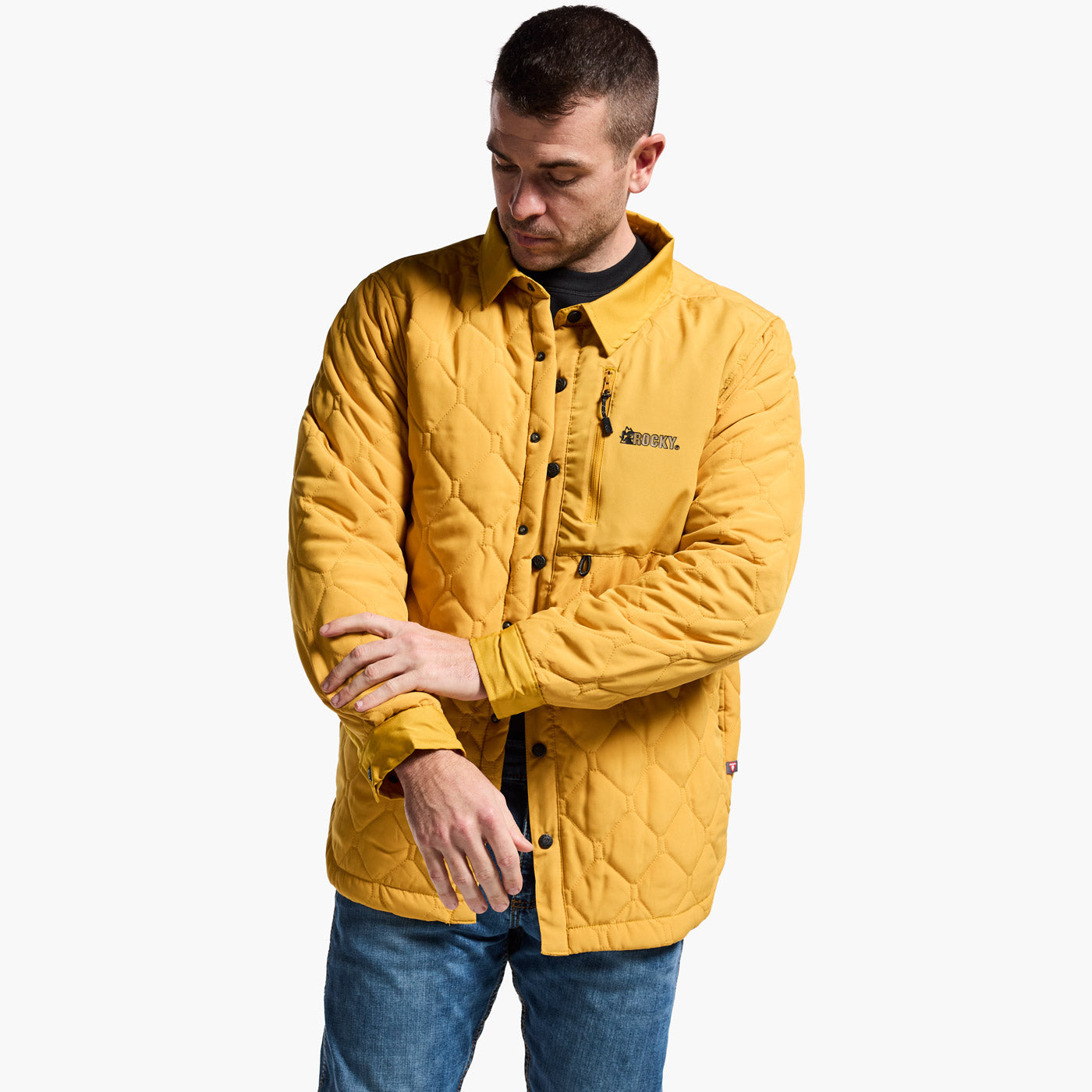Man wearing a yellow quilted jacket on a white background