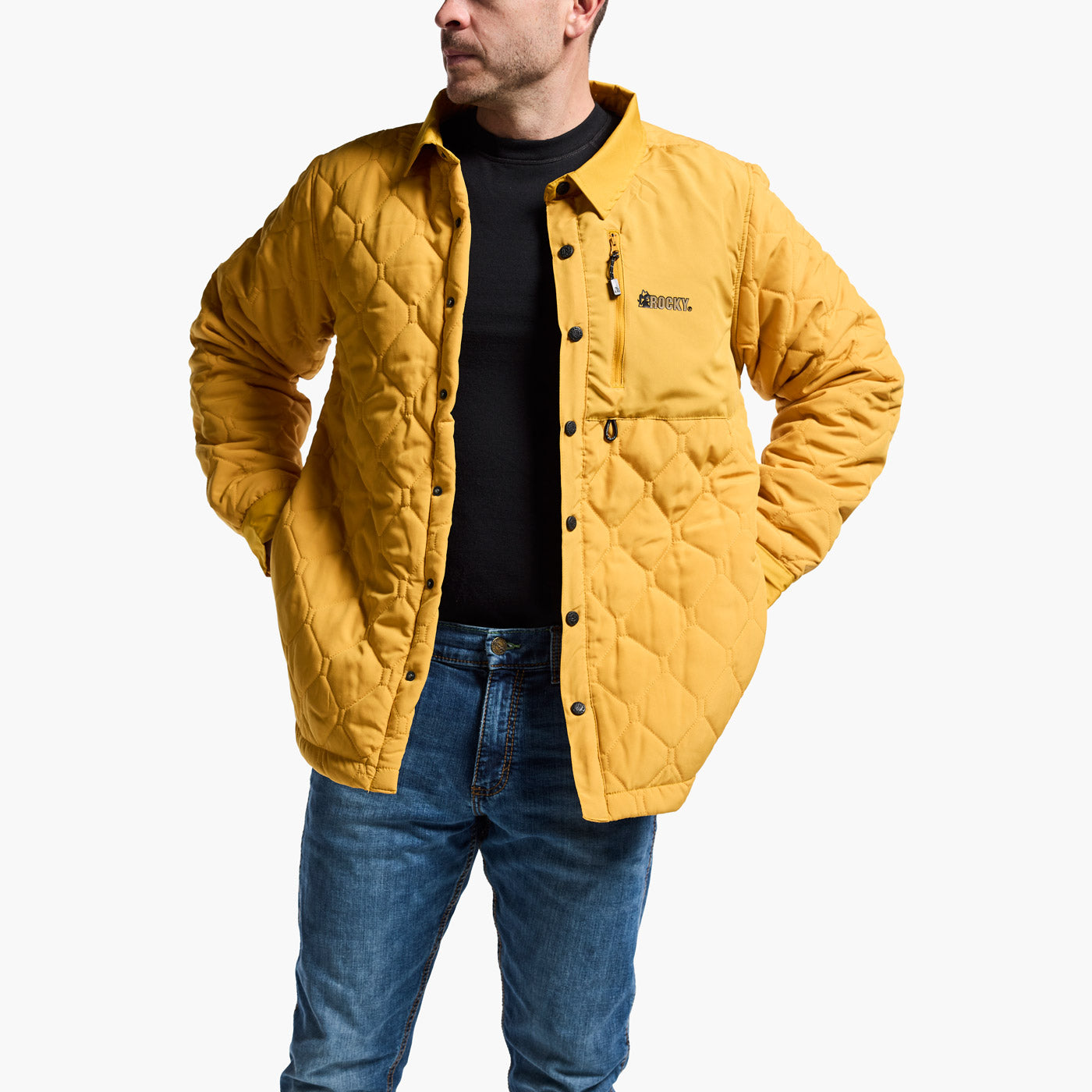 Man wearing a yellow quilted jacket with a brand logo on a white background