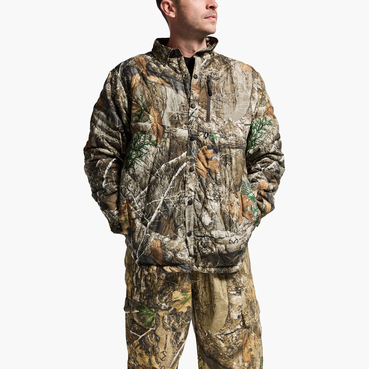 Person wearing a camouflage hunting suit on a white background