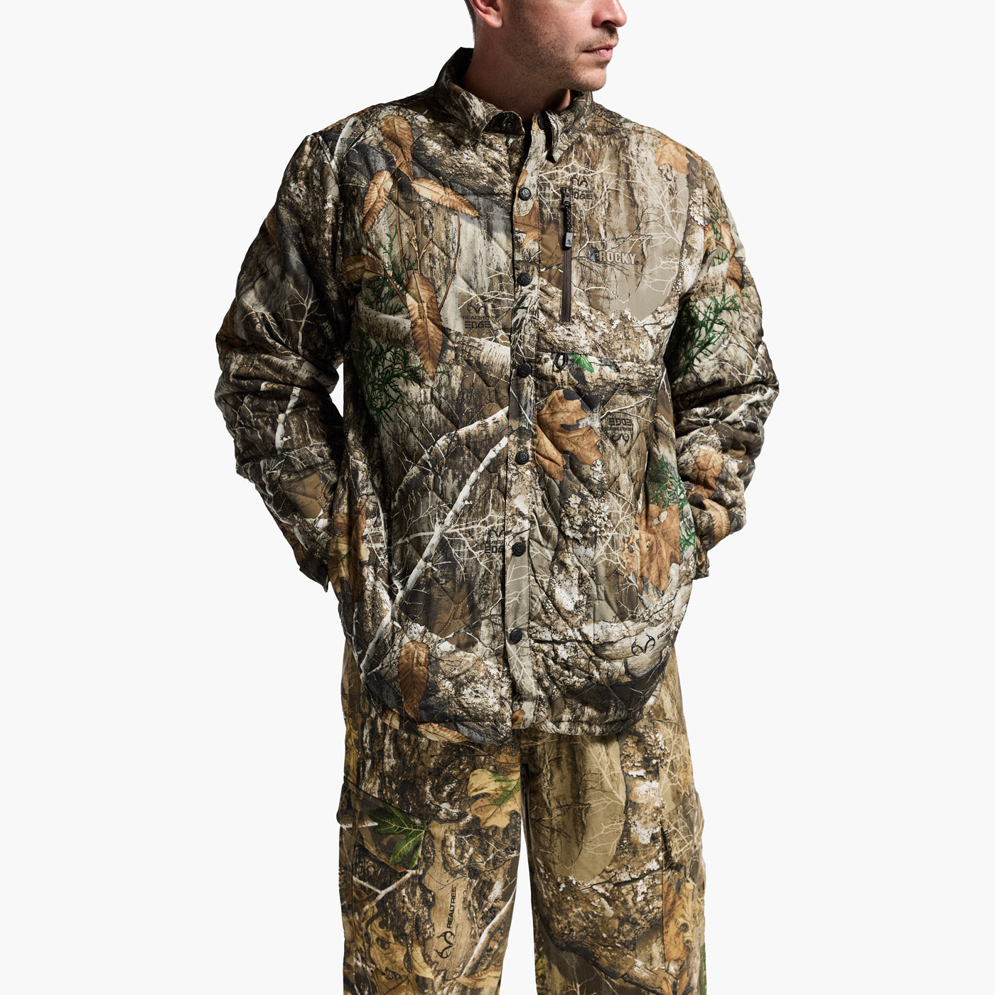 Person wearing a camouflage hunting suit on a white background