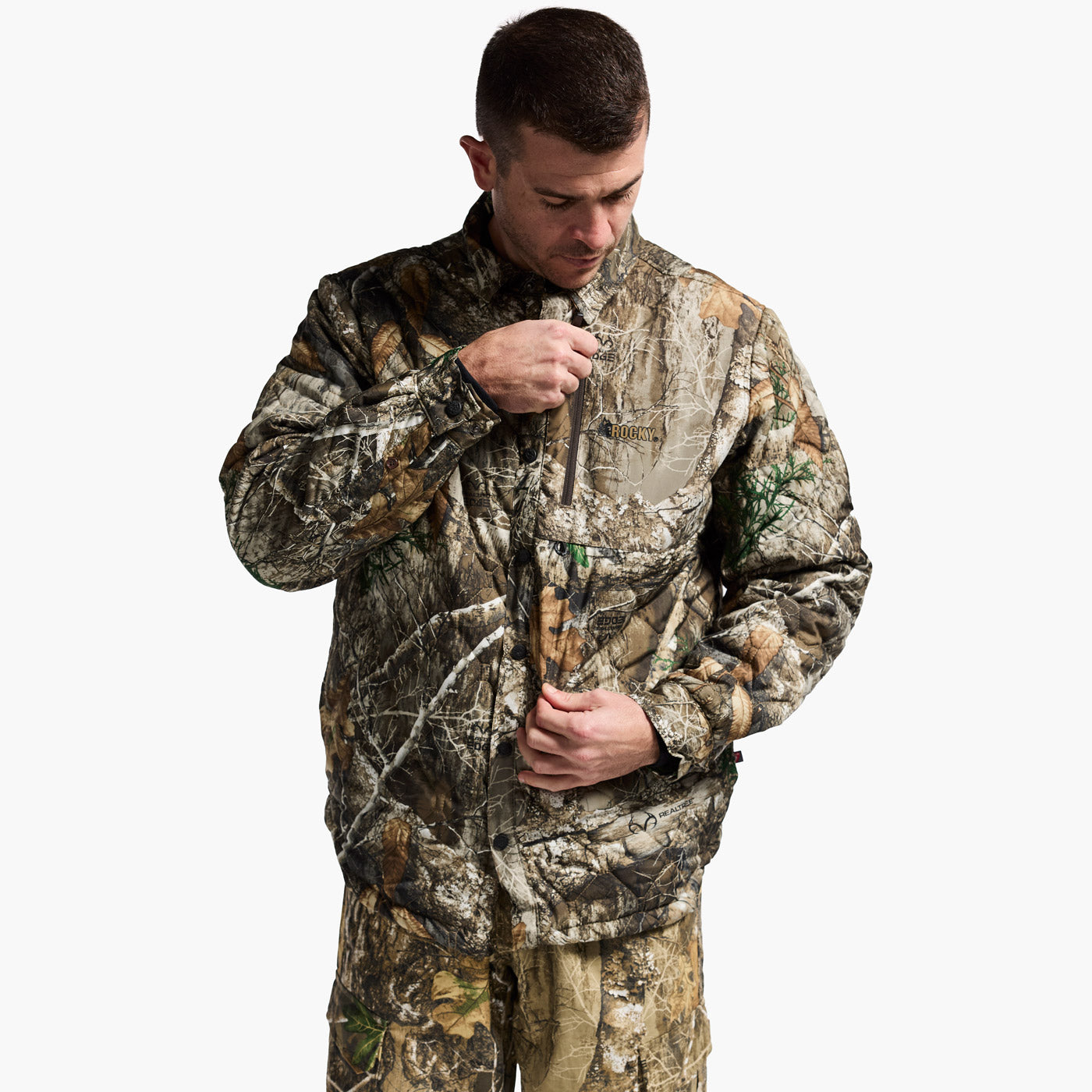 Man wearing a full camouflage hunting outfit on a white background