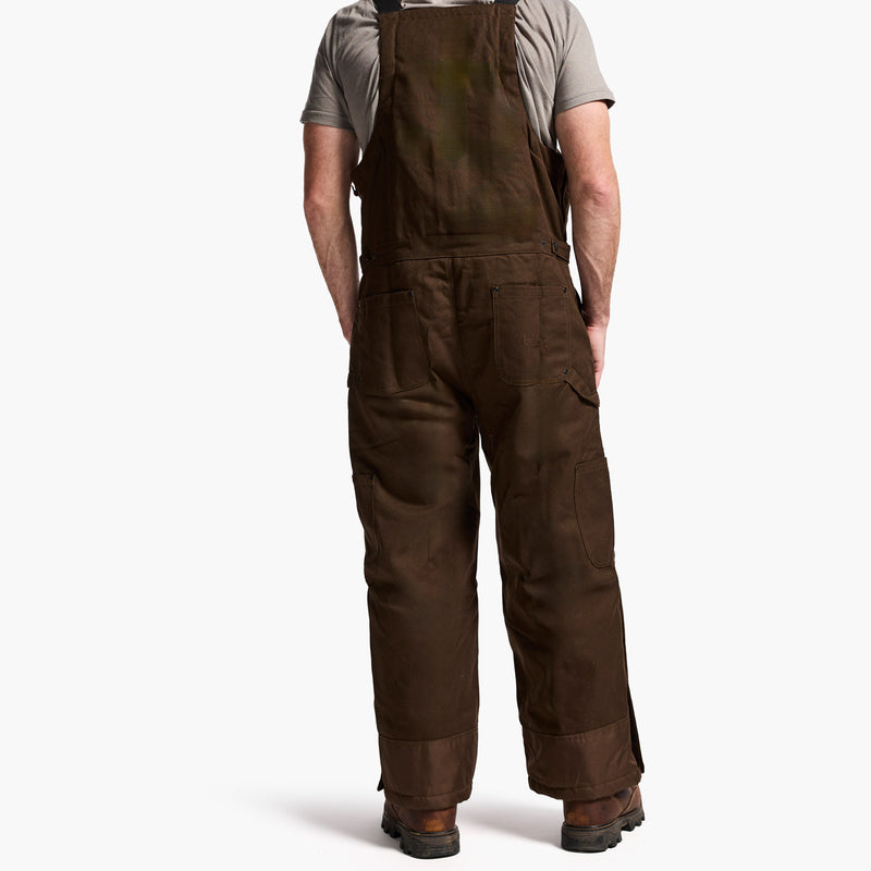 Brown overalls worn by a person on a white background