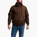 Man wearing a brown hooded jacket and blue jeans on a white background