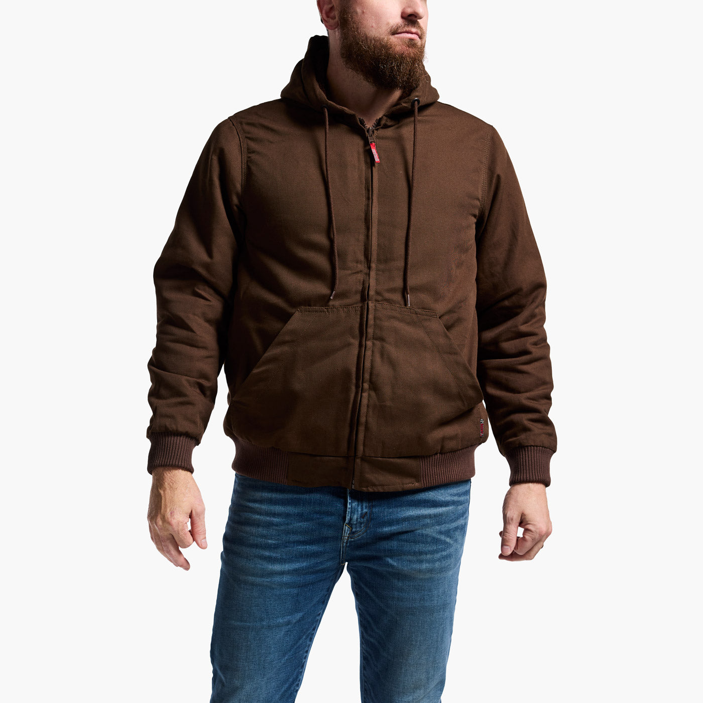 Man wearing a brown hooded jacket and blue jeans on a white background