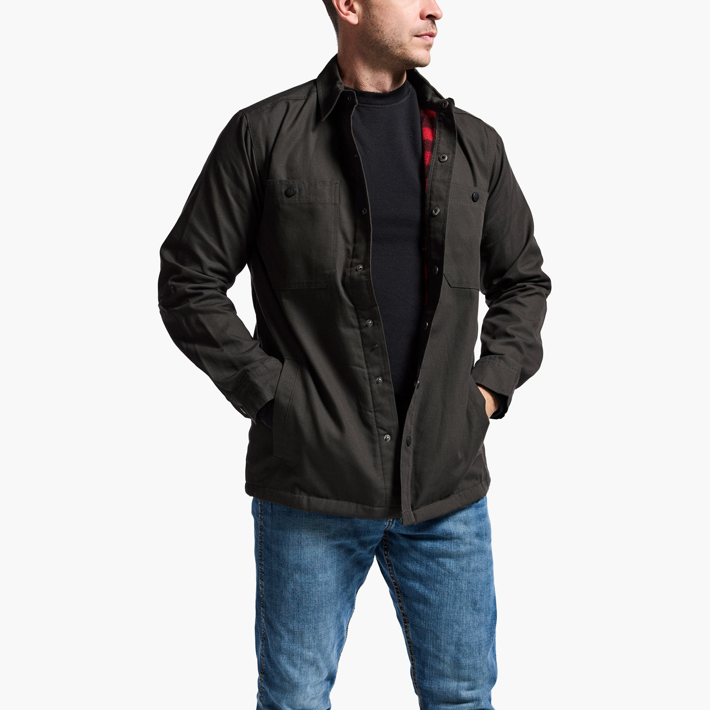 Man wearing a black jacket and blue jeans on a white background