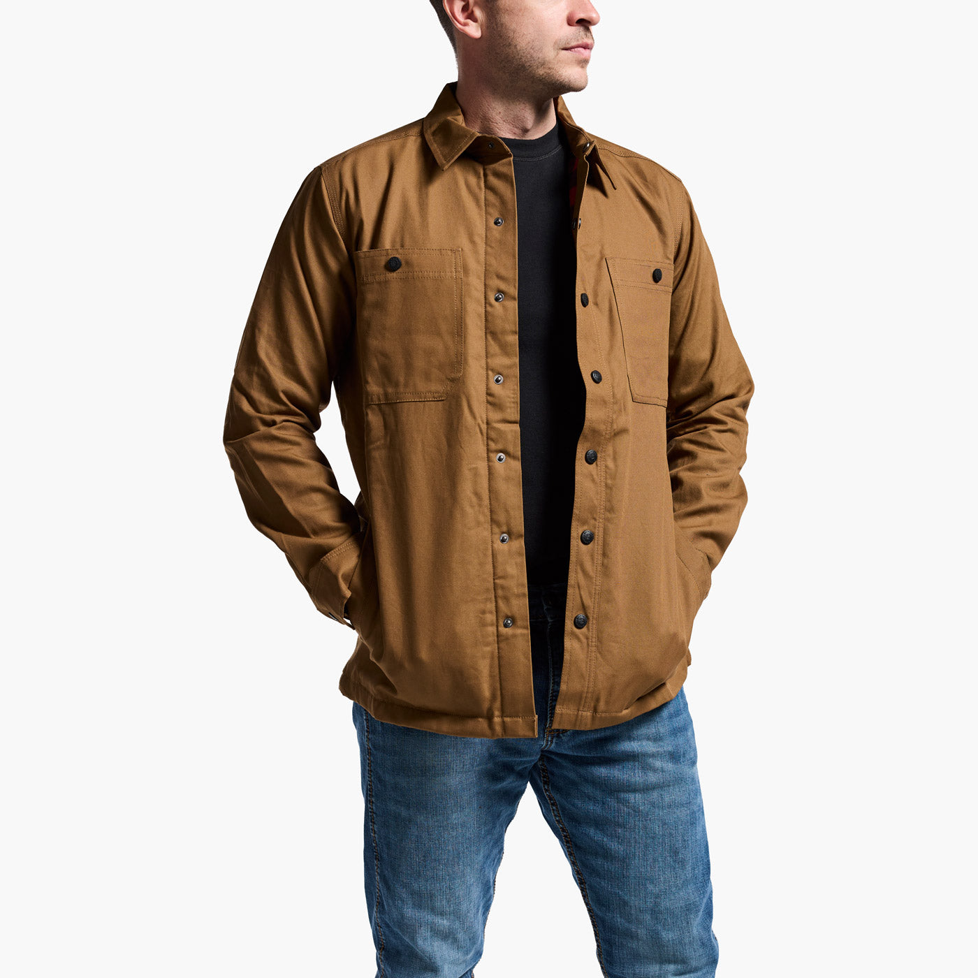 Man wearing a brown jacket and blue jeans on a white background