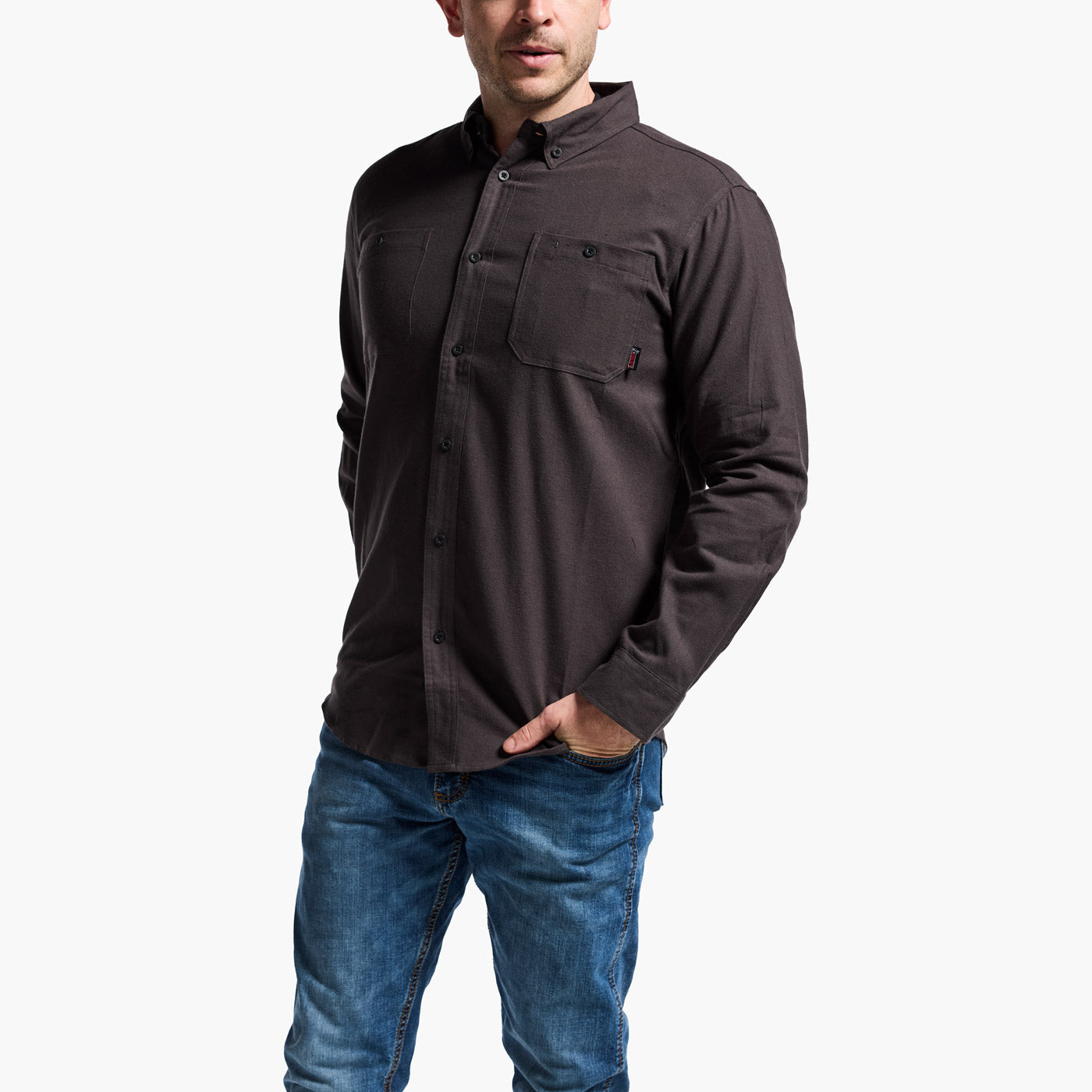 Man wearing a dark brown long-sleeve shirt and blue jeans on a white background