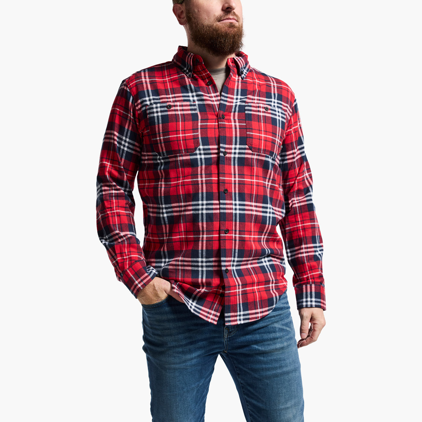 Man wearing a red and blue plaid shirt with a white background