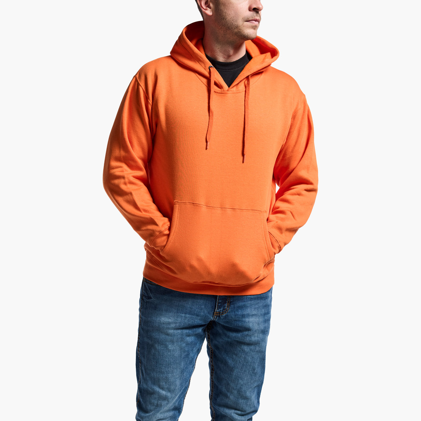 Person wearing an orange hoodie and blue jeans on a white background