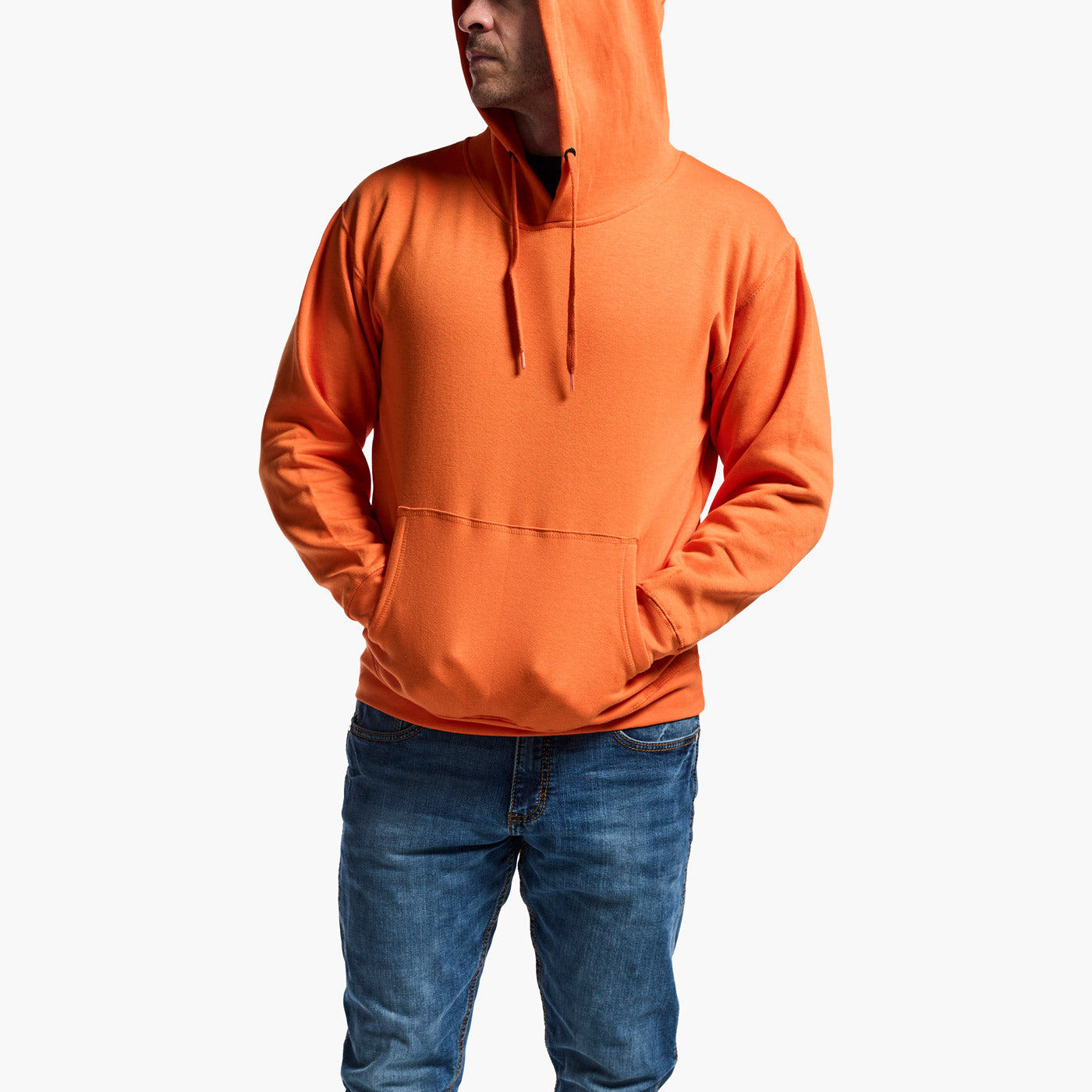 Person wearing an orange hoodie and blue jeans on a white background