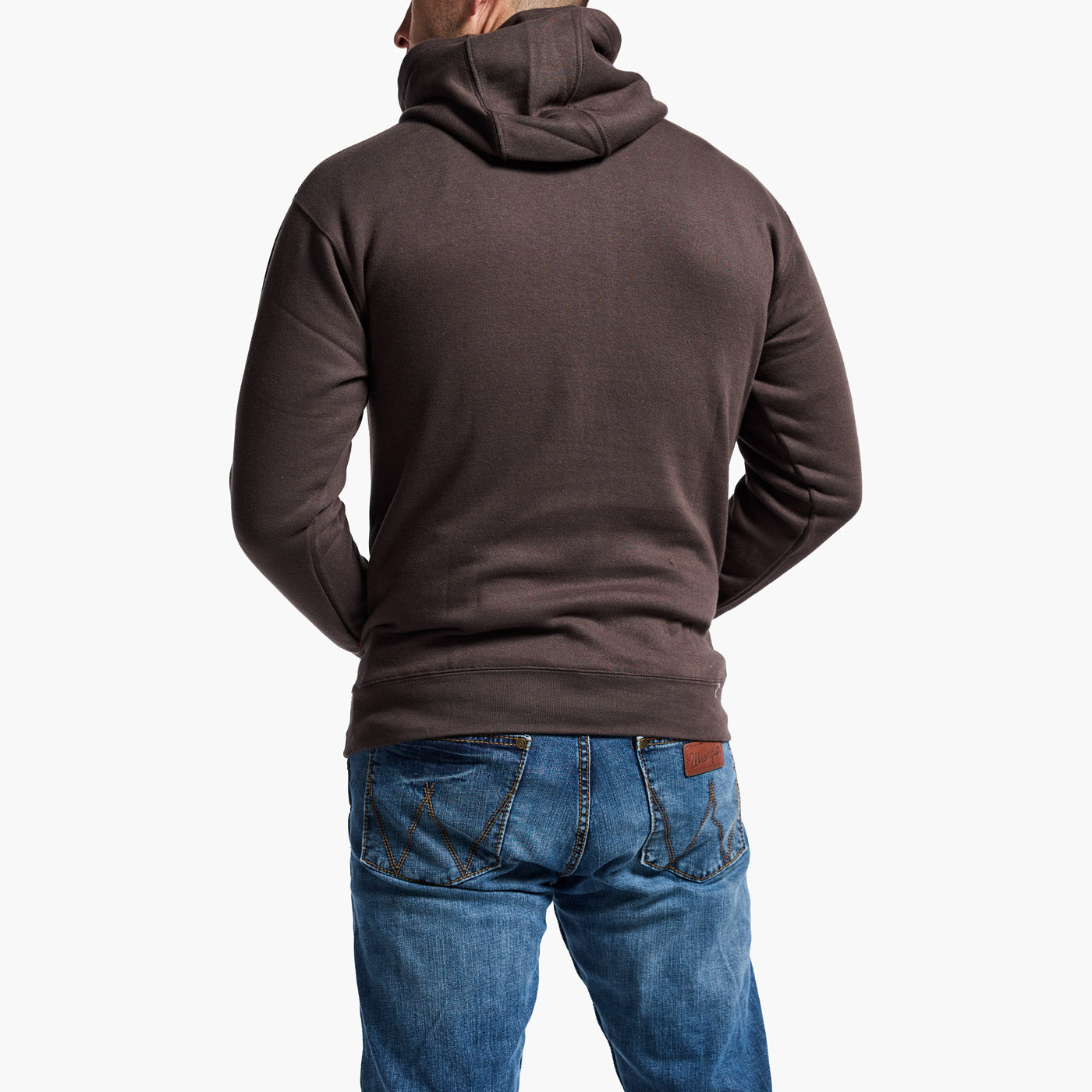 Person wearing a brown hoodie and blue jeans on a white background