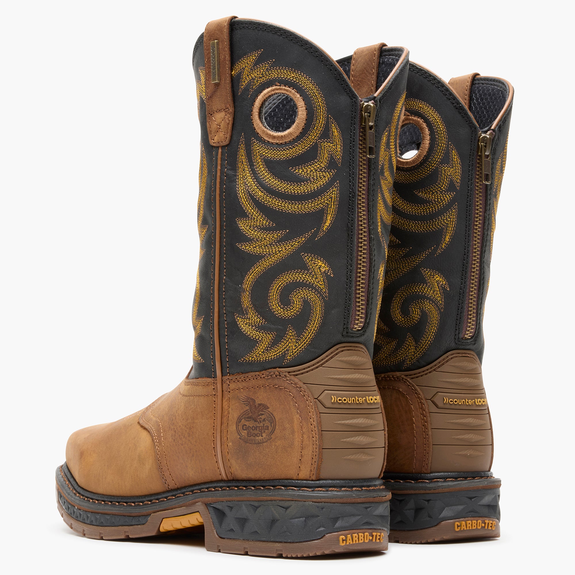 Pair of brown and black boots with intricate design on a white background